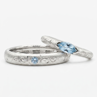 Vintage matching couple rings with gold filigree engravings and light blue stones.