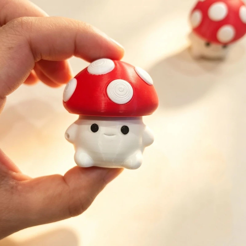 small red mushroom fidget clicker on hand