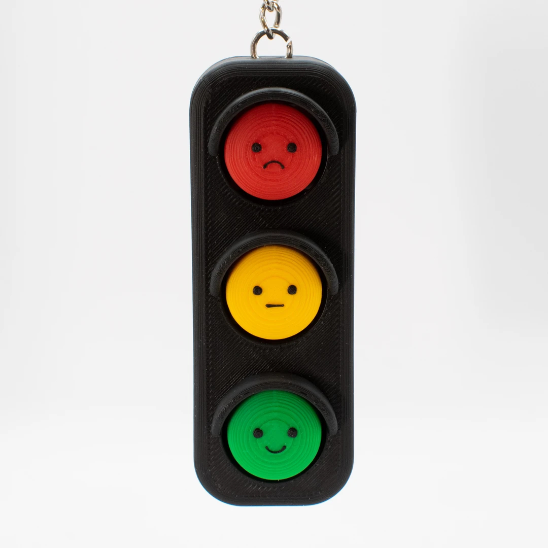 Cute traffic‑light shaped fidget clicker keychain made of PLA. 3 clickable buttons with fun faces